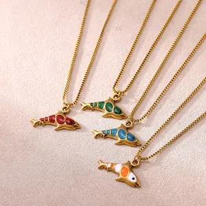 Close-up of four colorful enamel shark pendants on gold stainless steel box chains