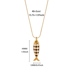 Detailed sizing for ocean-themed gold fish pendant with black and white enamel scales