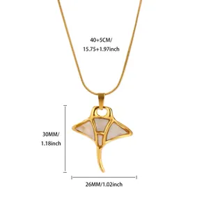 Close-up of golden manta ray pendant with white shell inlay on a fine snake chain
