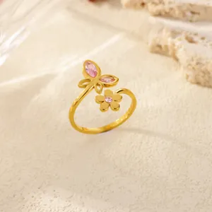 Detail showing pink zircon butterfly and flower motifs on gold stainless steel ring