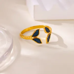 Close-up of golden adjustable open ring with blue enamel leaf fish tail details