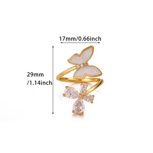 Detail of gold open ring featuring a white enamel butterfly and zircon flower accents