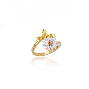 Detailed view of 18K gold plated heart ring with camellia flower and orange crystals