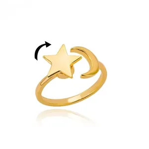 Detail of spinning gold moon and star ring with stress-relief rotating feature