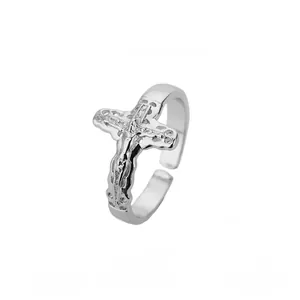 Close-up of silver crucifix cross ring with adjustable band and jesus relief detail