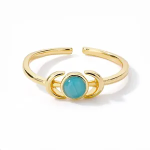 Detail of adjustable gold ring with turquoise center and crescent moon accents