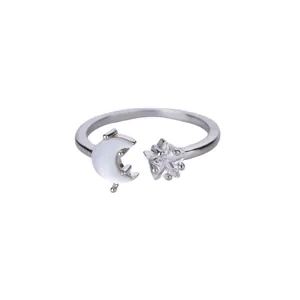 Detailed close-up of silver moon and star adjustable ring with shimmering zircon inlay