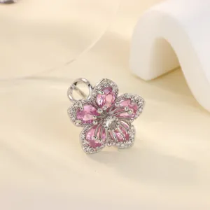 Detailed view of pink zircon flower ring with pear-shaped petals on minimalist background