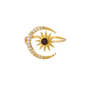Elegant gold celestial ring featuring a sparkling moon and a black stone sun motif