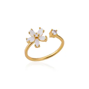 Close-up of gold open ring with a blooming flower motif and sparkling zircon stone