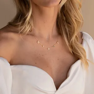 Custom gold stainless steel necklace featuring letter charms and colorful birthstones
