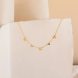 Customized gold necklace with letters M B S and birthstone charms on a fine chain