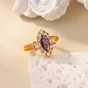 Macro detail of 18K gold ring featuring a marquise purple zircon and vintage beadwork