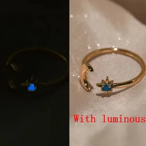 Detailed comparison showing star and moon gold ring with blue luminous effect in the dark