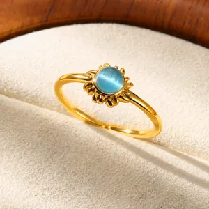 Elegant gold-tone open ring featuring a round blue moonstone set in a wavy sunburst frame