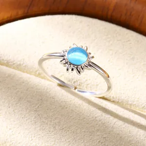 Detailed view of silver sunburst ring with light blue moonstone on a velvet box