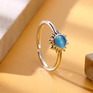 Detail view of sunflower ring with blue gemstone and silver adjustable band