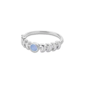 Detailed macro view of silver celestial ring featuring moonstone and lunar phase motifs
