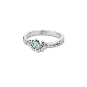 Macro shot of silver ring featuring pear-cut light blue stone and milgrain detail