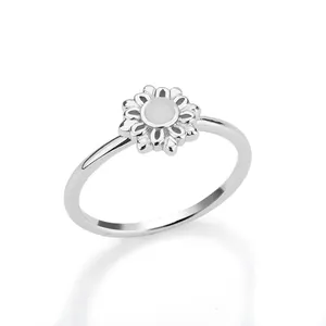 Macro shot of silver flower ring featuring a polished moonstone inlay in the center