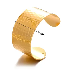 Macro shot of 36mm wide gold cuff bracelet featuring a textured hammered metal surface