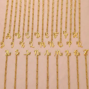 Collection of gold butterfly initial necklaces from A to Z on textured pink background