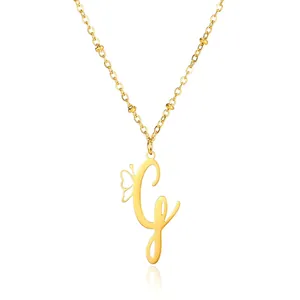 Detail of gold butterfly initial G pendant with intricate bead chain necklace