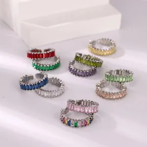 Close-up of stackable silver rings with vibrant rectangular cut colorful zircons