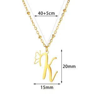 Close-up of gold stainless steel K-letter pendant necklace with butterfly wing design