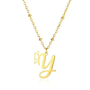 Close-up of golden letter y pendant with hollow butterfly and beaded chain detail