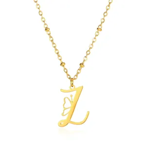 Detail of golden stainless steel satellite chain with letter L and butterfly pendant