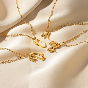 Gold stainless steel initial letter necklaces with butterfly charm on silk fabric