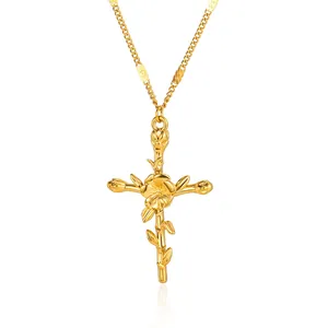 Detailed close-up of gold-plated cross necklace with a central blooming flower design