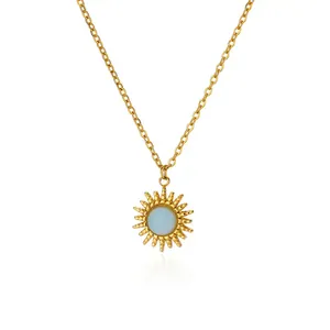 Detailed close-up of a gold sunburst pendant necklace with a blue opal stone center