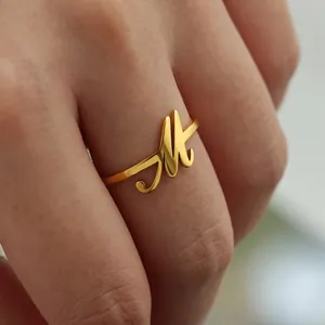 Detail macro-opname van een verstelbare vergulde ring met een cursief letter M ontwerp
