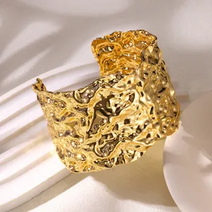 Modern 18K gold plated wide cuff bracelet with irregular lava texture and open design