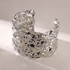 Macro detail of silver irregular textured wide open cuff bangle with liquid metal finish
