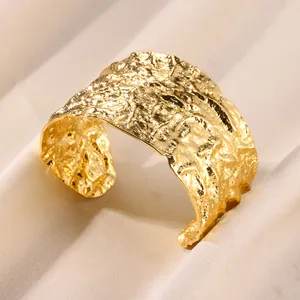 Macro shot of 18K gold plated wide cuff bracelet featuring unique crushed lava texture