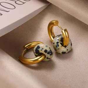Gold stainless steel hoop earrings featuring natural spotted stone pendants on satin