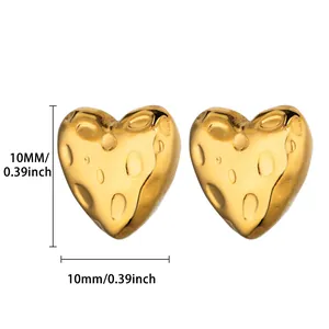 Detail of 10mm golden heart stud earrings with unique hammered metal cheese texture