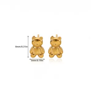 Detailed macro view showing the 18K gold-plated bear stud earrings with matte textures