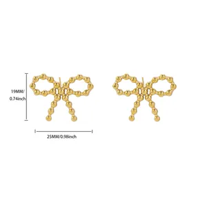 Detailed view of gold bow knot earrings with textured metallic bead surface finish