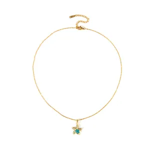 Golden starfish pendant necklace with turquoise shell inlay and sparkling zirconia on a fine chain