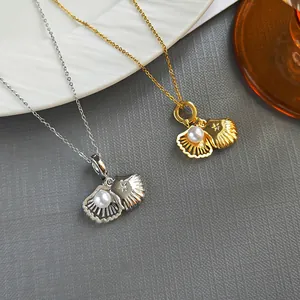 Elegant French shell pendant necklace with pearl and star engraving in gold and silver