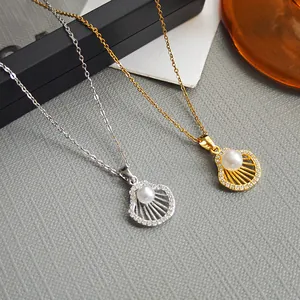 Elegant gold and silver scallop pearl necklaces with zircons on a luxury display base