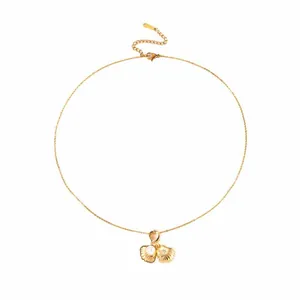 Detail of gold shell pendant with pearl and star engraving on titanium steel chain
