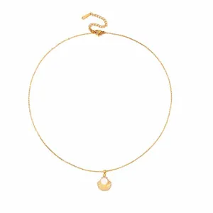 Close-up of gold scallop shell pendant with pearl and crystals on a fine link chain