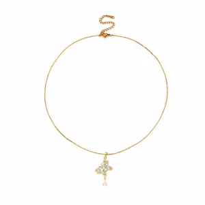 Golden butterfly necklace with blue heart zircons and teardrop pendant on white background