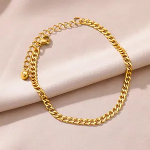 Adjustable golden curb link anklet with lobster clasp and round ball pendant detail