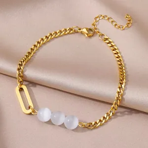 Gold stainless steel anklet with shell charms and white beads on champagne satin